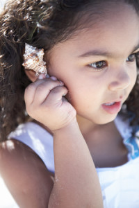 Girl Listening to a Seashell