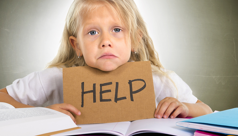 Sweet Little School Girl Holding Help Sign In Stress With Books